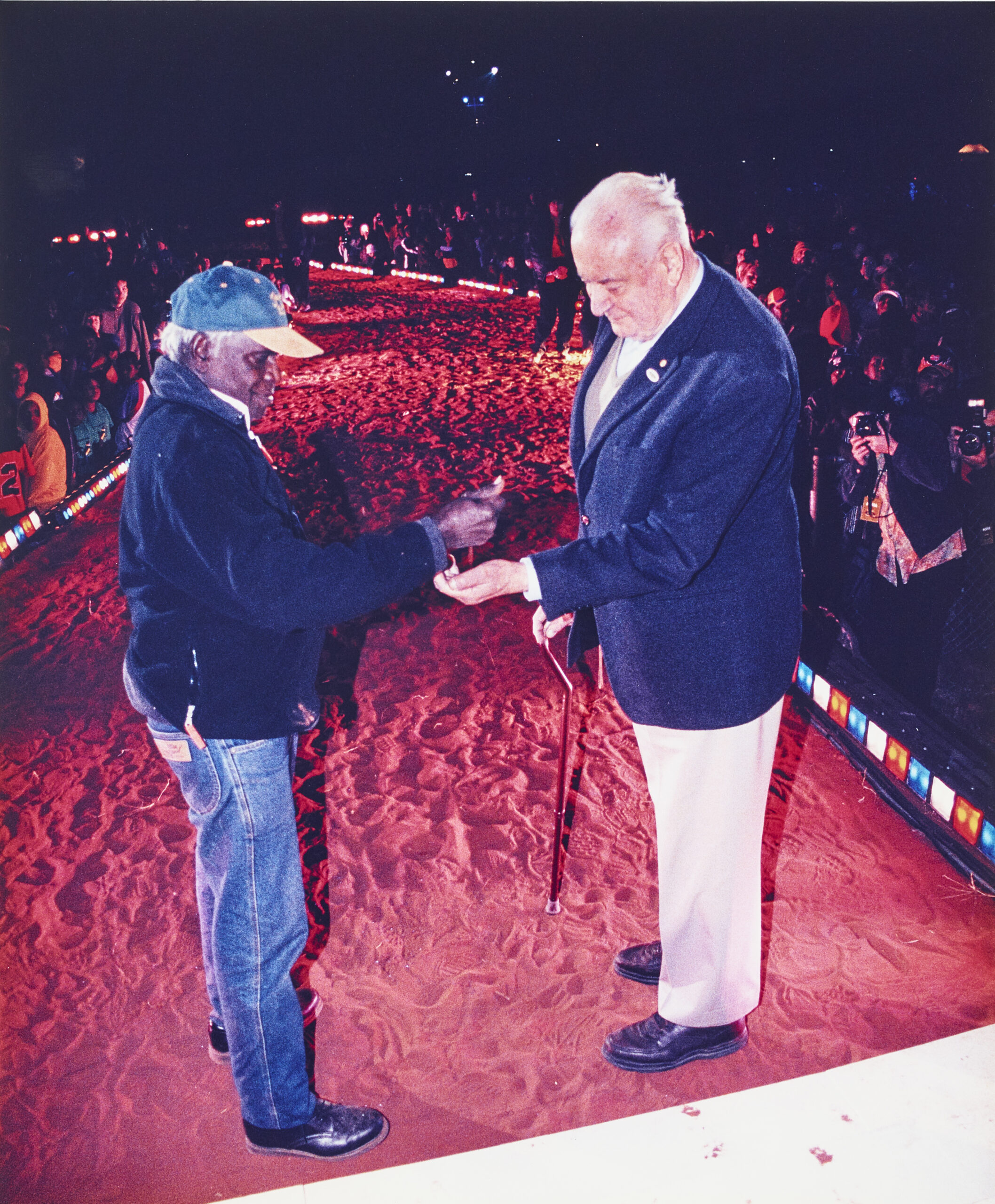 VICTOR LINGIARI, SON OF VINCENT LINGIARI, POURS SOIL IN THE HAND OF THE FORMER PRIME MINISTER GOUGH WHITLAM AT YEPERRENY