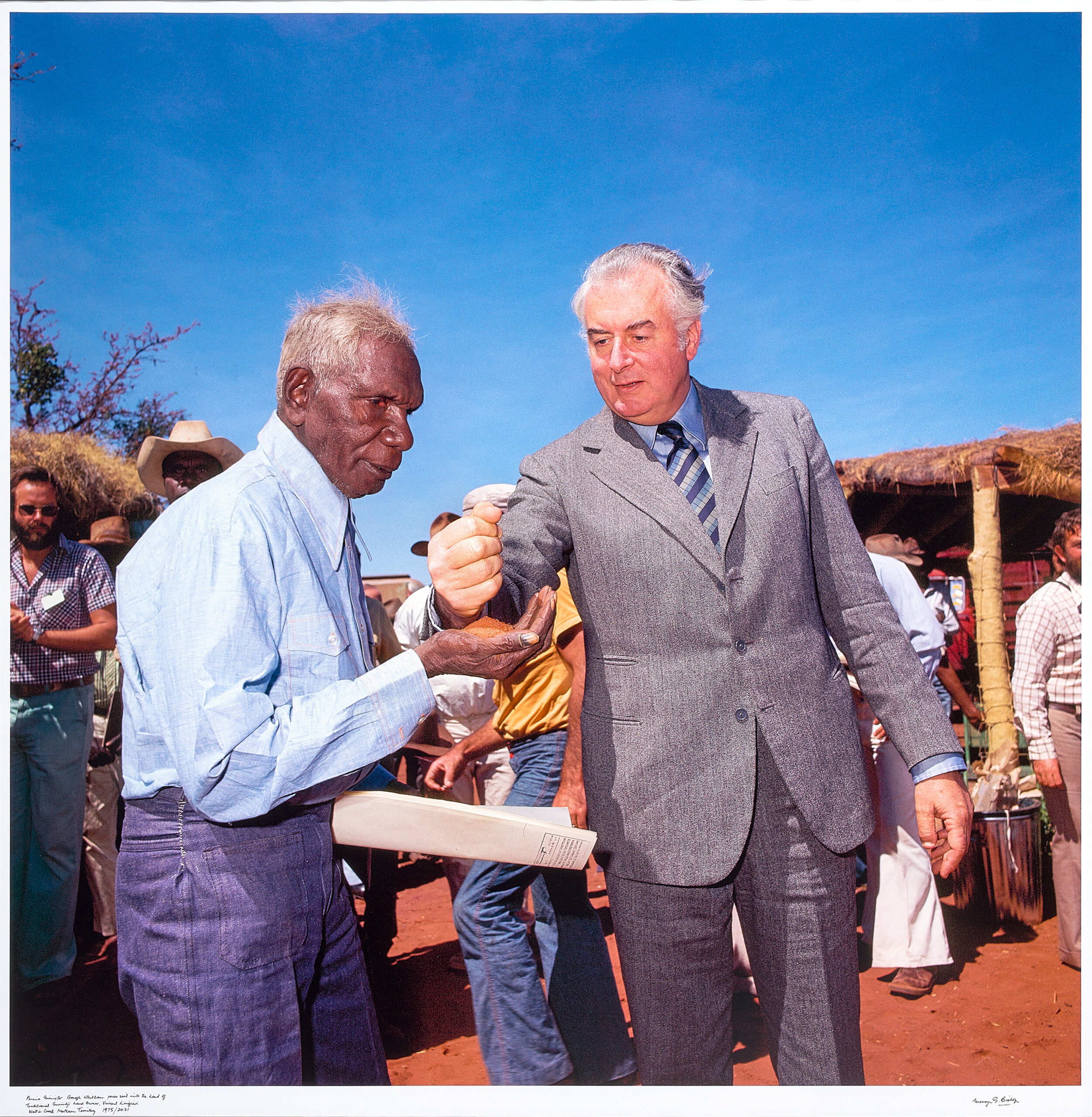 Prime Minister Gough Whitlam pours soil into the hands of traditional landowner, Vincent Lingiari